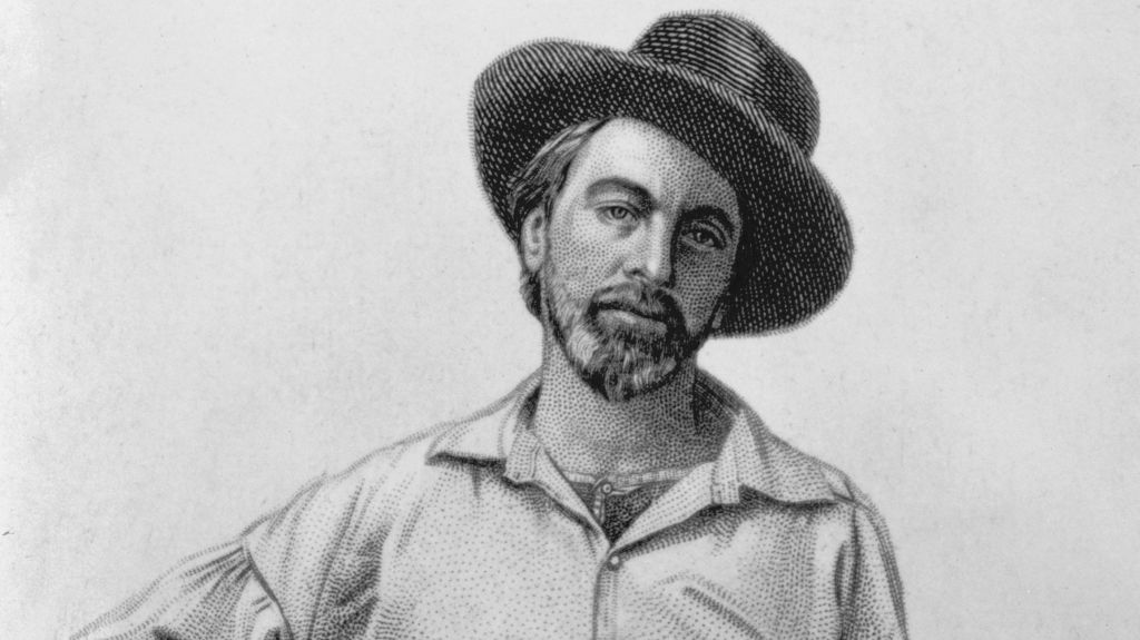 A portrait of Walt Whitman as a young man, bearded, wearing a hat and white shirt.